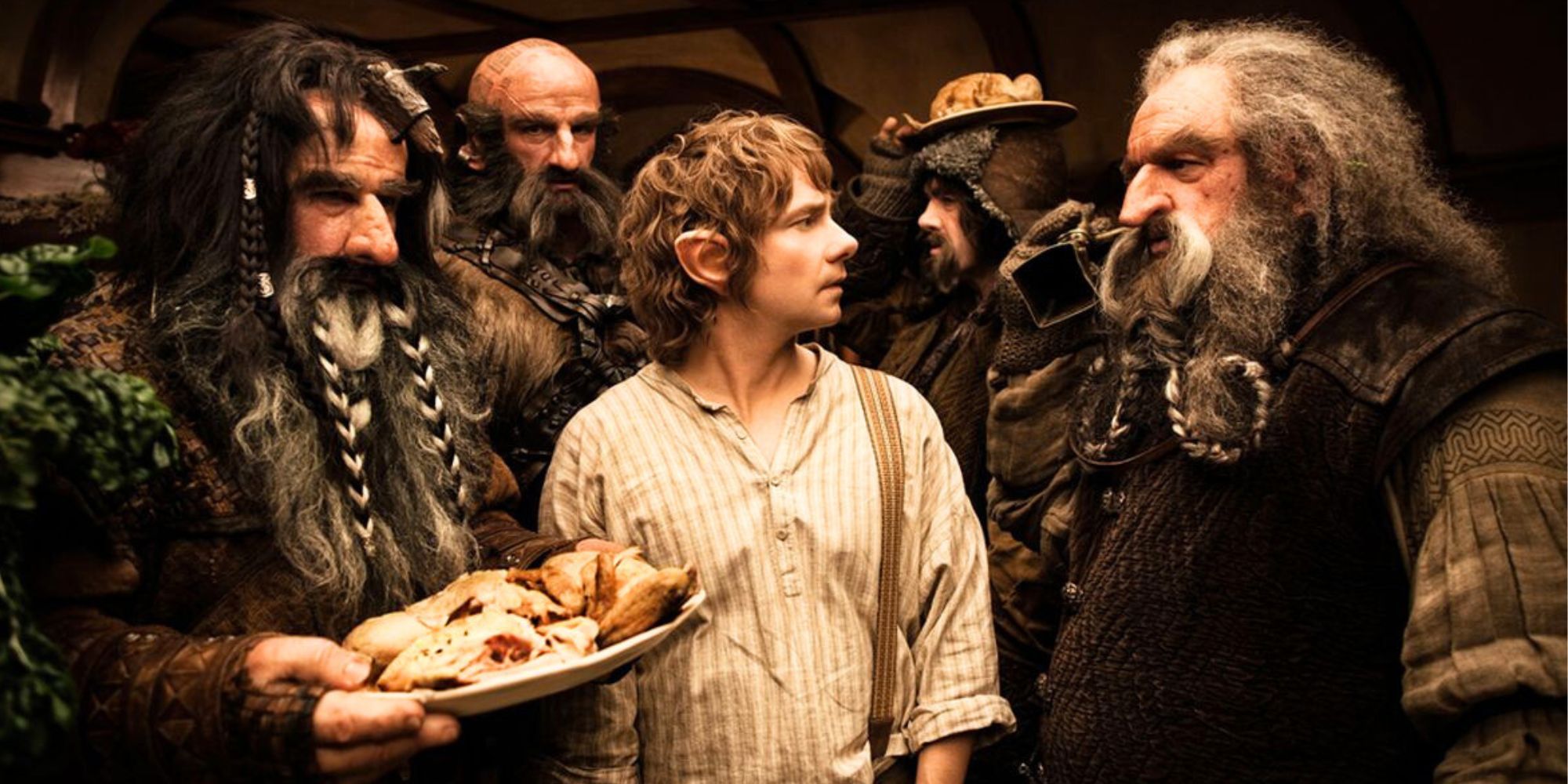 Martin Freeman surrounded by several individuals in The Hobbit An Unexpected Journey