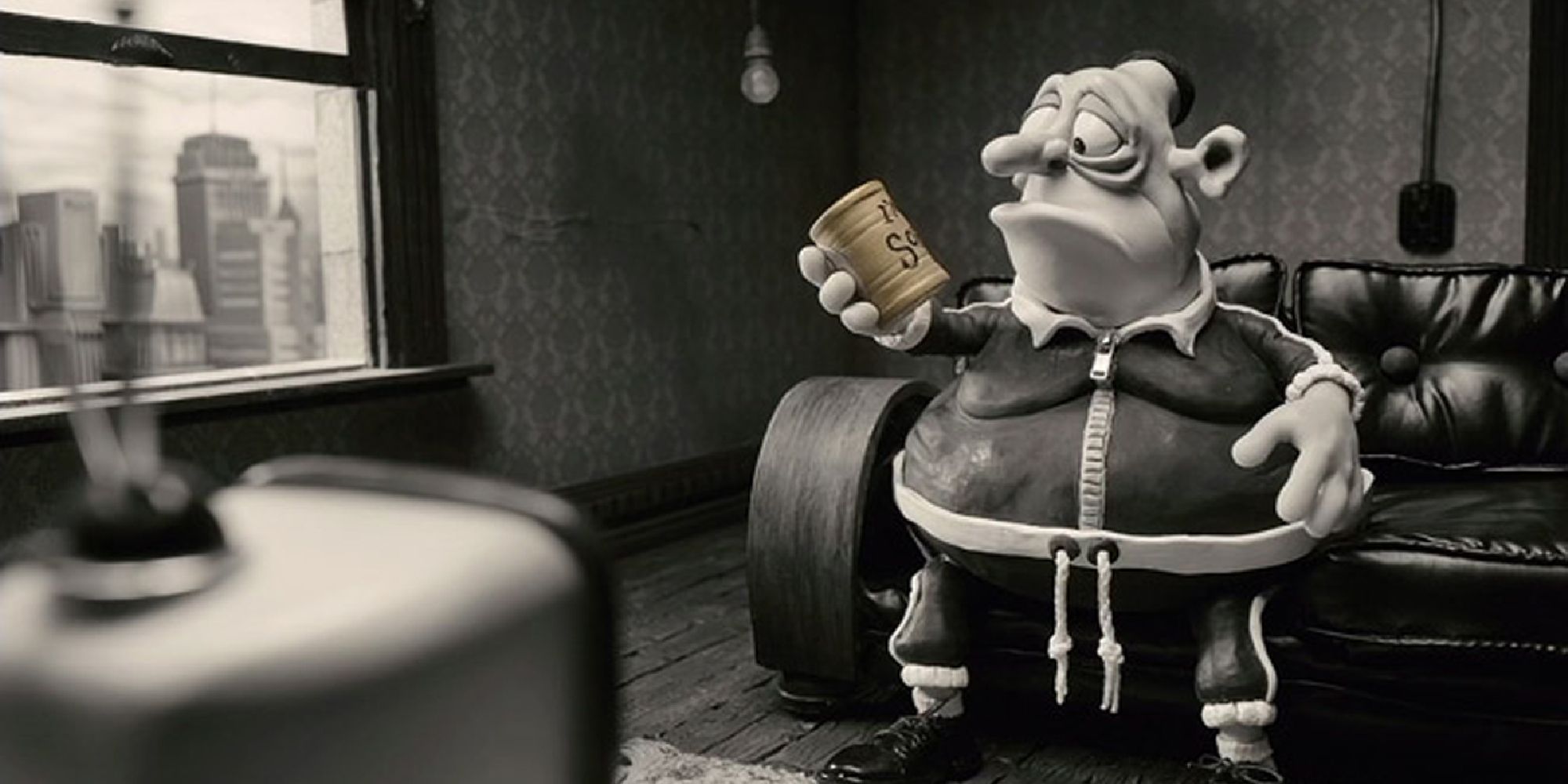 A man looking at a can while sitting on a couch in Mary and Max - 2009