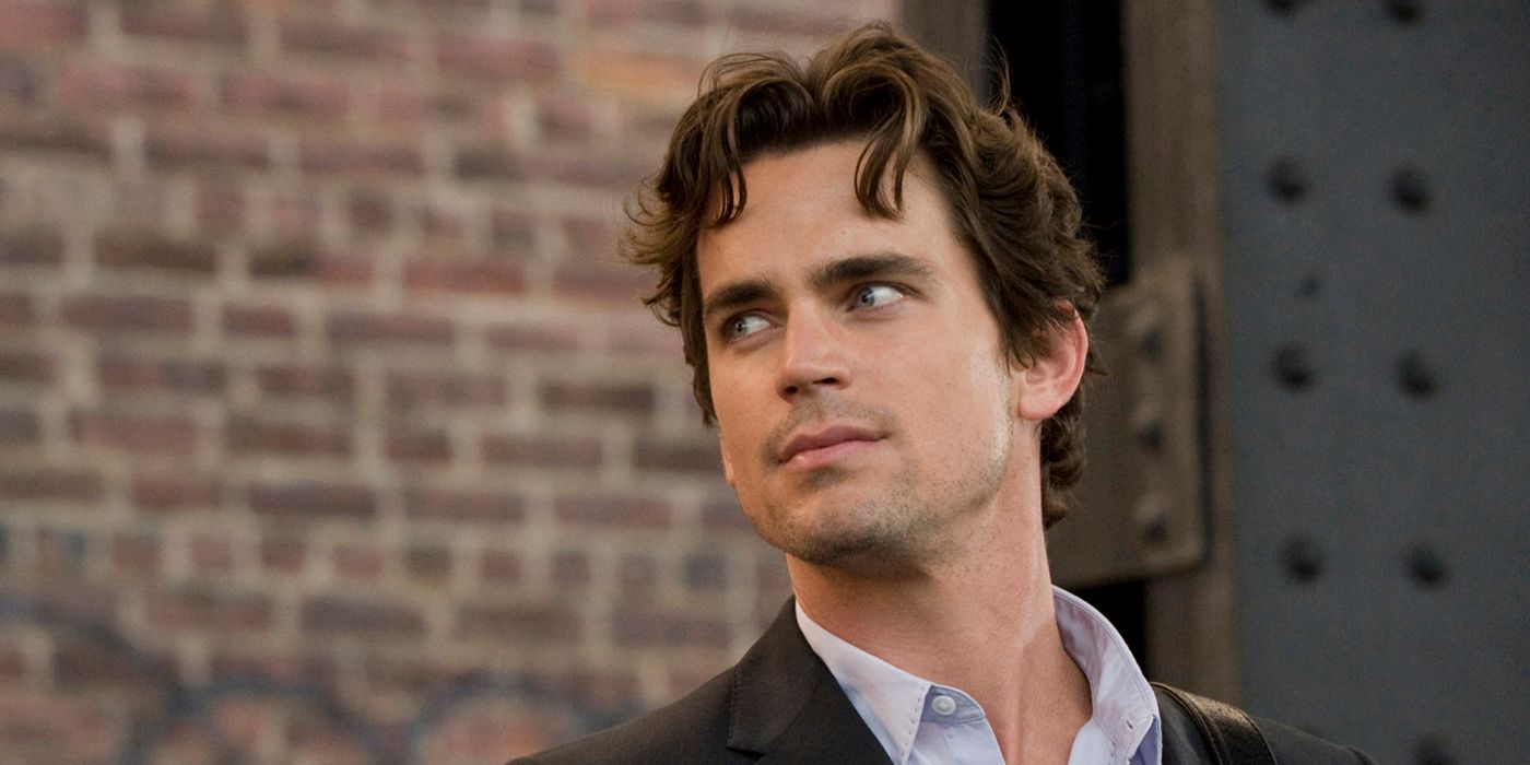Matt Bomer as Neal Caffrey, looking at someone off camera in front of a brick wall in White Collar