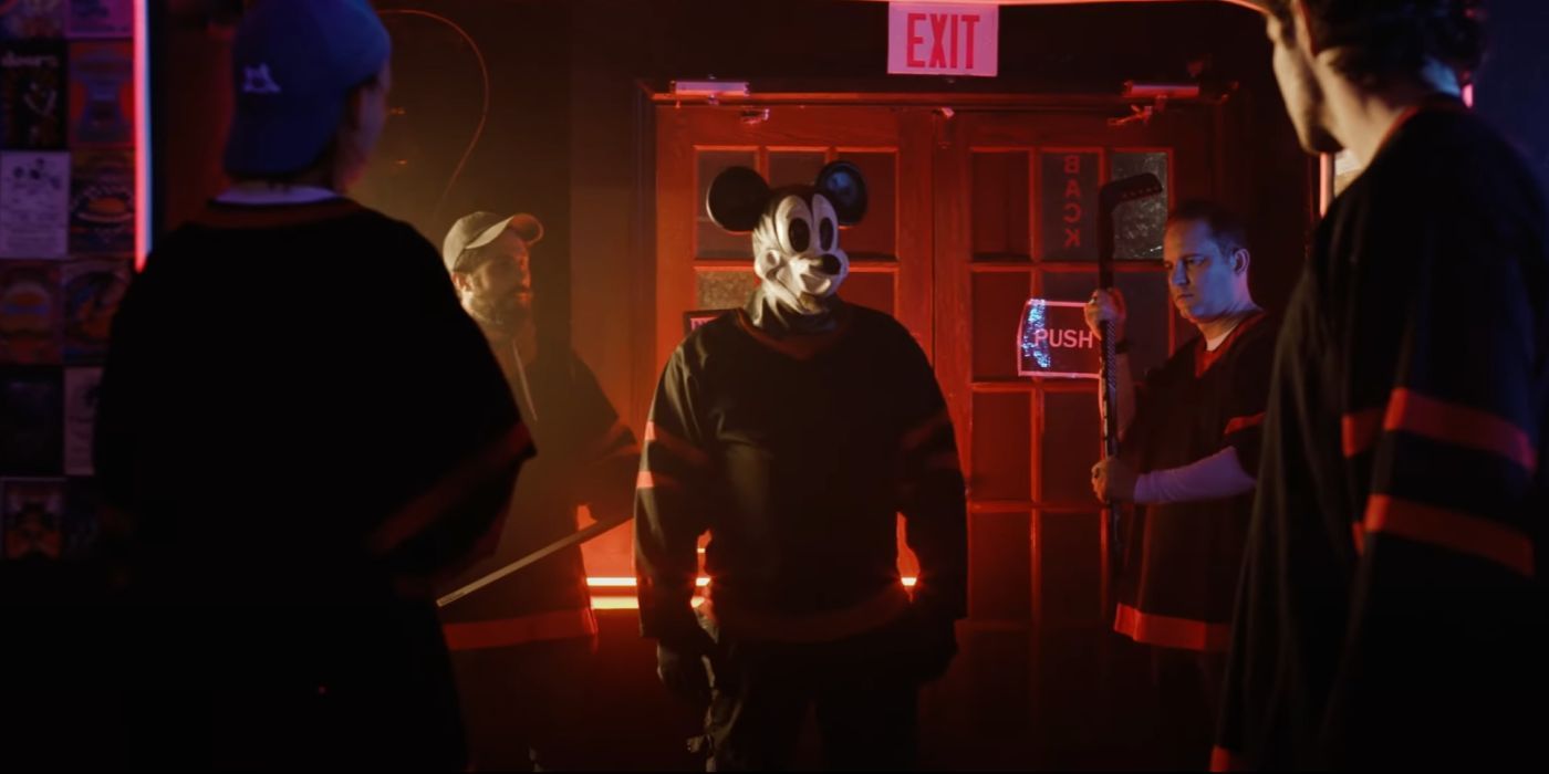 A killer dressed up as Mickey Mouse, surrounded by henchmen in Mickey's Mouse Trap