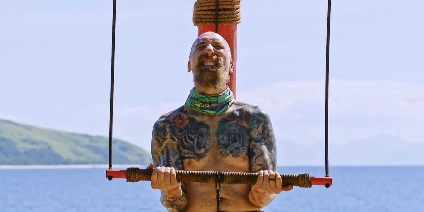 Mike Gabler with tattoos balancing a rod in in Survivor 43 challenge 