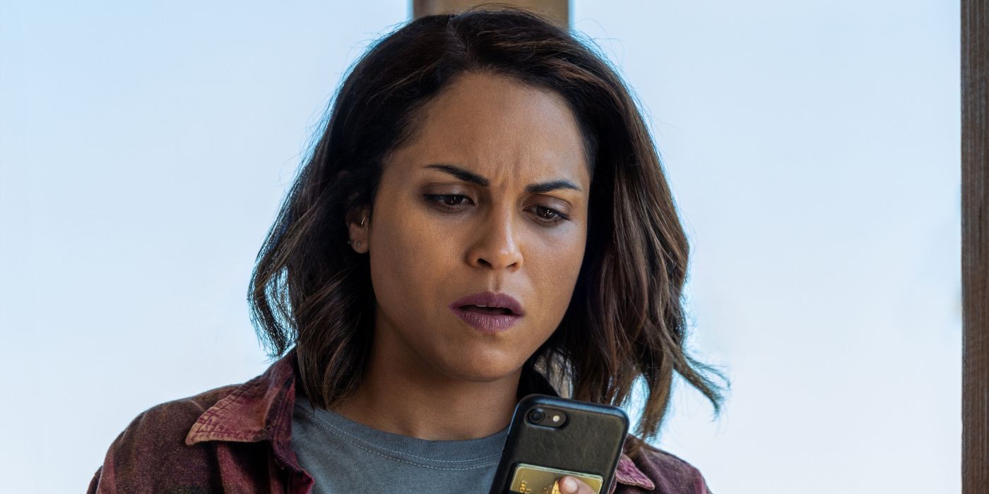 Monica Raymund as Jackie Quinones, examining her phone in Hightown Season 3