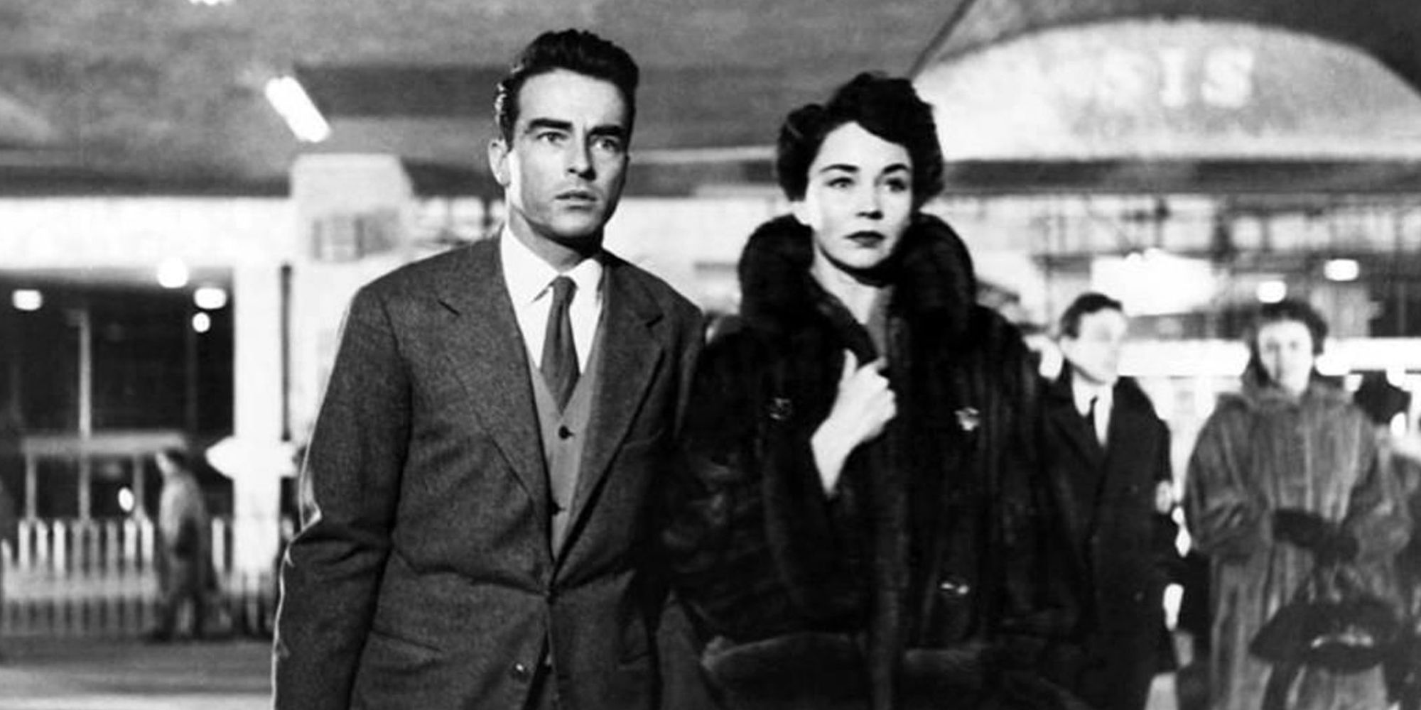 Montgomery Clift and Jennifer Jones walking together in an airport in Terminal Station (1953)