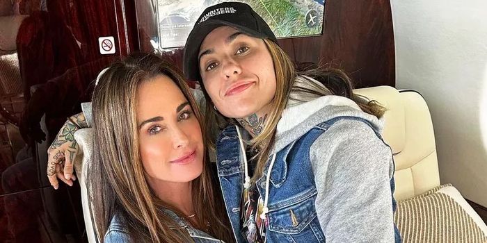 Morgan Wade sitting on Kyle Richards' lap in a plane