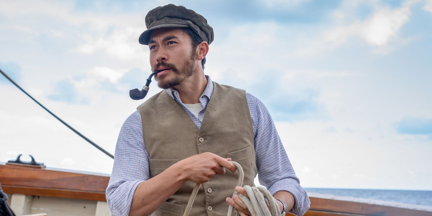 Henry Golding, smoking a pipe, in The Ministry of Ungentlemanly Warfare