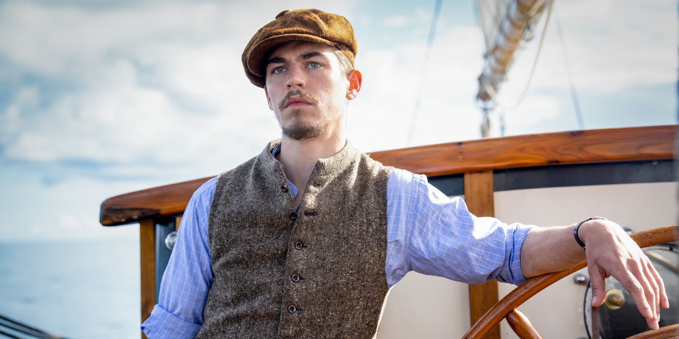 Hero Fiennes Tiffin in The Ministry of Ungentlemanly Warfare leans on the boat's wheel