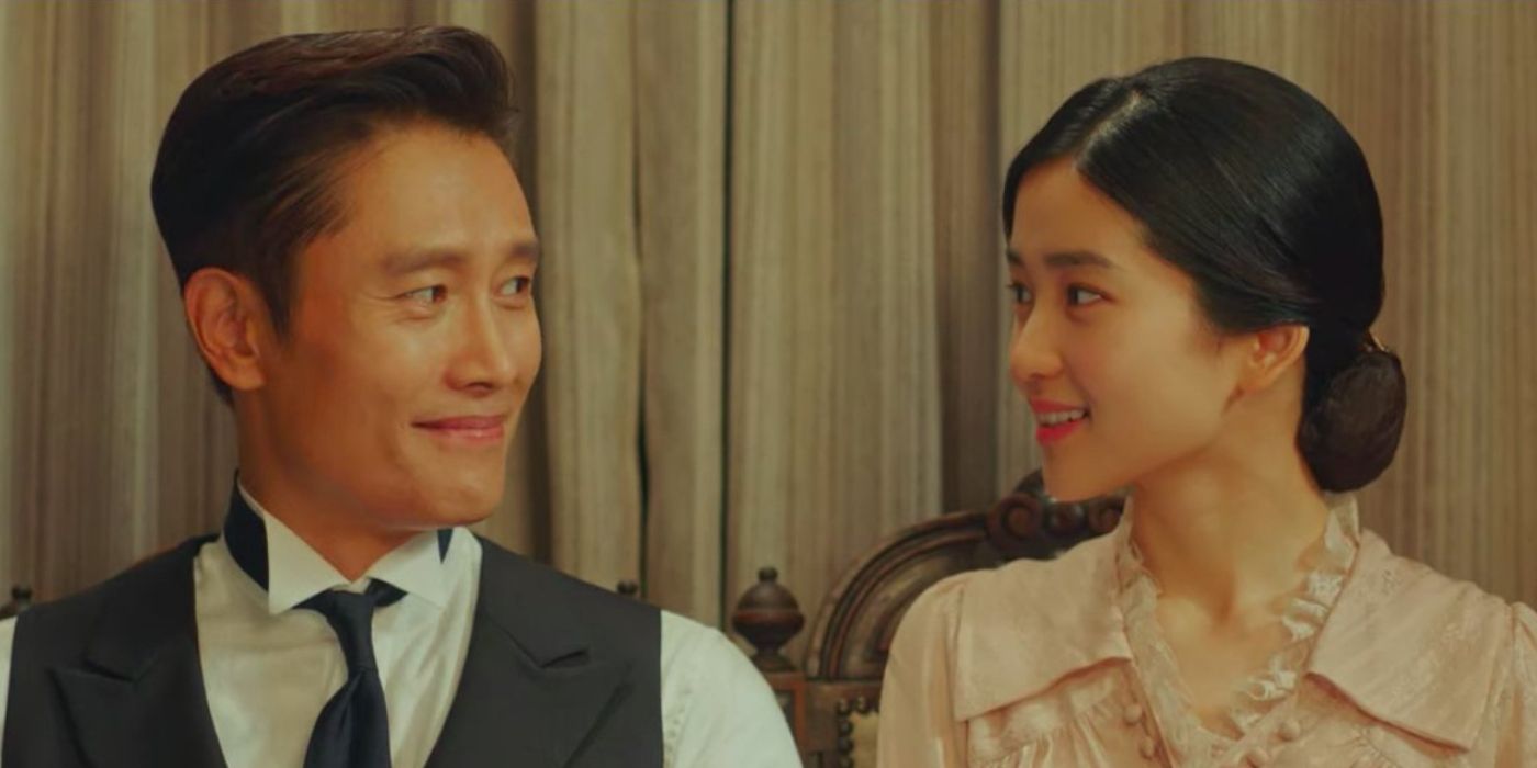 Eugene and Ae-shin (Lee Byung-hun and Kim Tae-ri) smile at each other as they pose for a photo in Mr. Sunshine