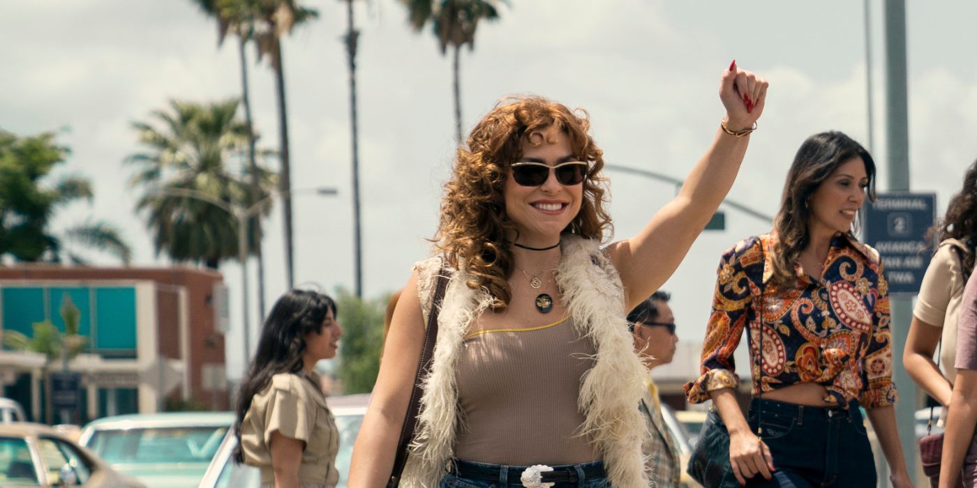 Paulina Davila as Isabel, wearing sunglasses and raising her fist in the air, in Griselda