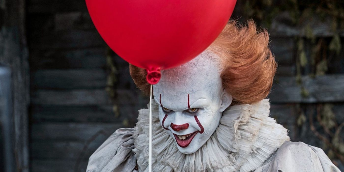 Pennywise holds a red balloon in 'It' (2017)