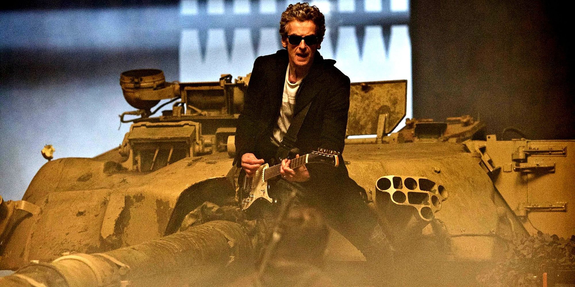 the Twelfth Doctor playing the guitar with sunglasses on, on top of a tank