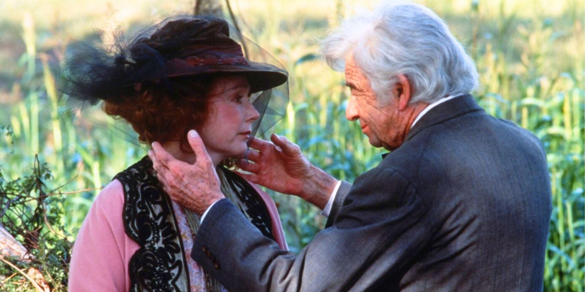 Piper Laurie facing Walter Matthau while sitting in a field in The Grass Harp (1995)