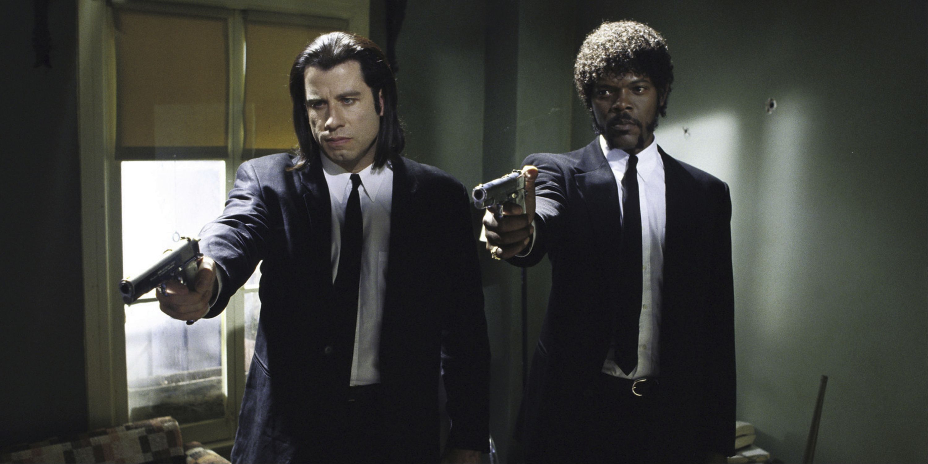 John Travolta as Vincent Vega and Samuel L. Jackson as Jules Winnfield pointing guns about to shoot in Pulp Fiction