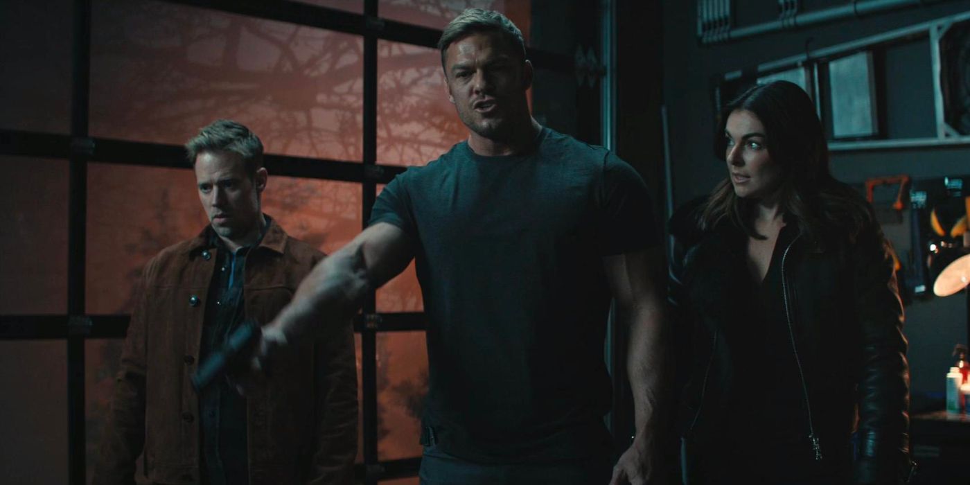 Jack Reacher and two of his allies stand in a hardware room interrogating people at gun point.