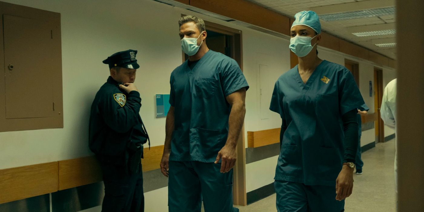 Jack Reacher and Neagley walk through a hospital disguised as nurses while a police officer talks into his radio next to them.