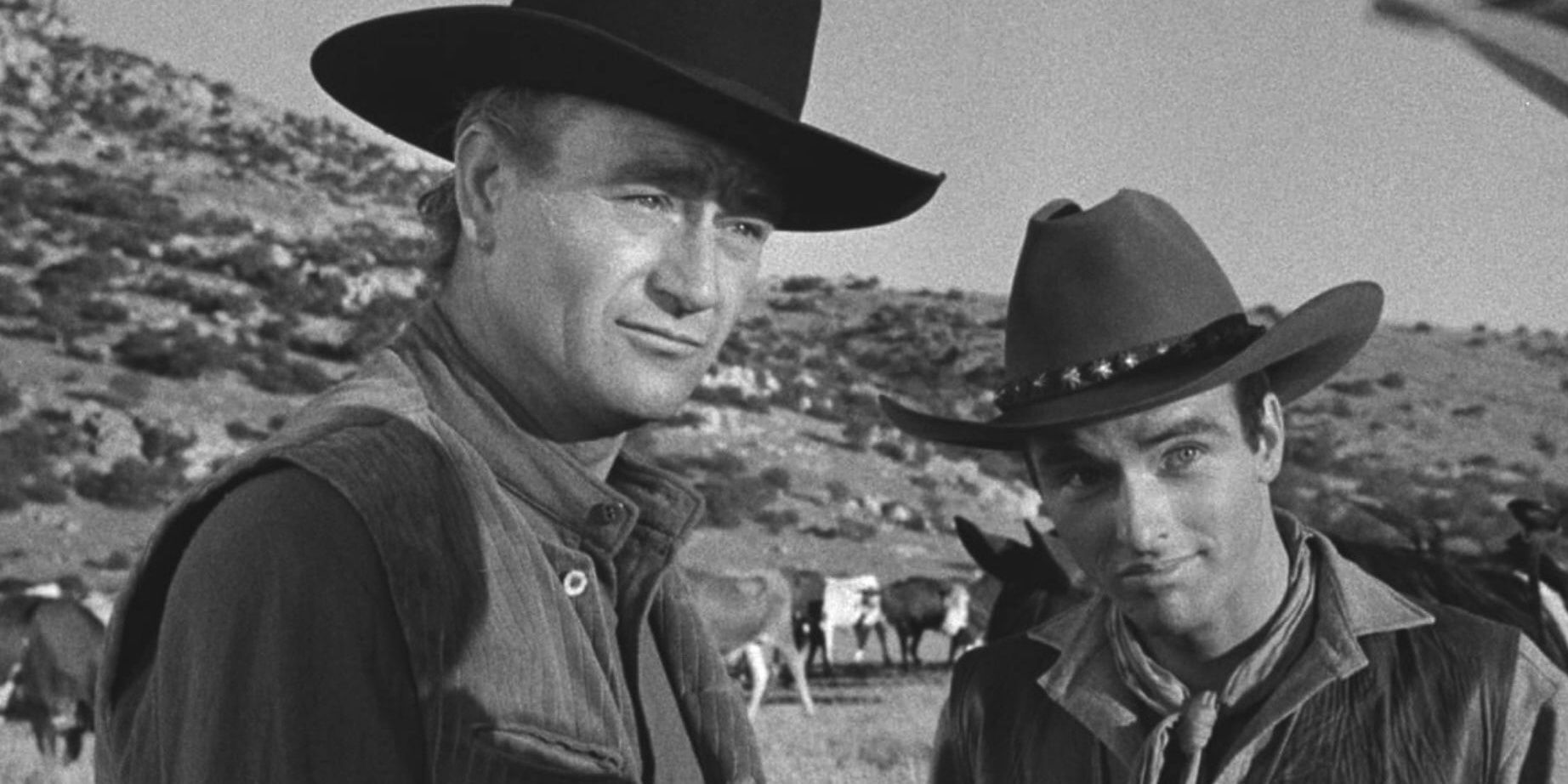 John Wayne as Thomas Dunson and Montgomery Clift as Matt Garth looking at a person offscreen in Red River
