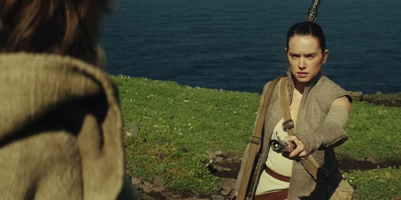 Rey offers Luke his lightsaber in Star Wars: Episode VII - The Force Awakens