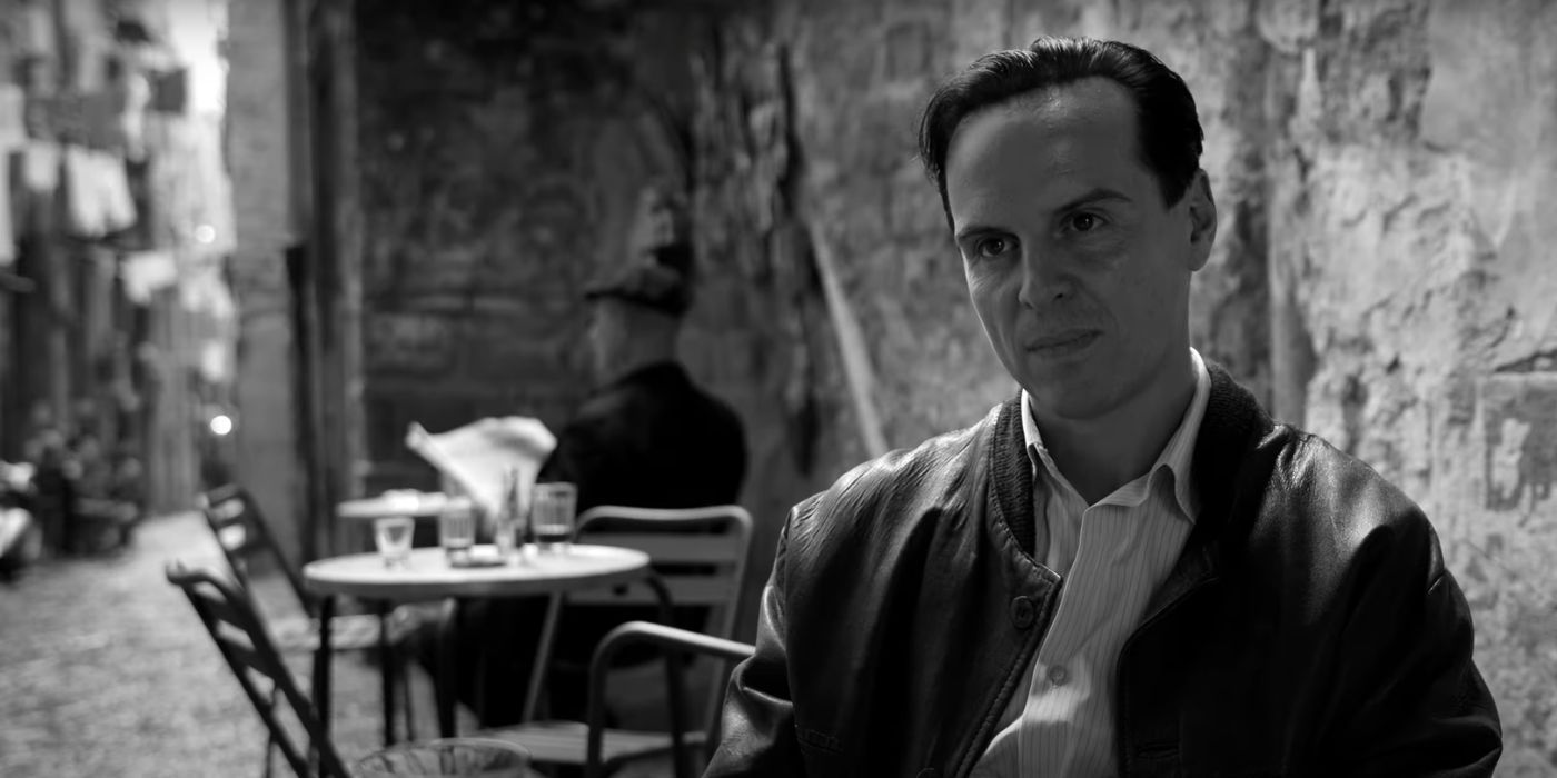 Andrew Scott as Tom Ripley, sitting a cafe table, in Ripley