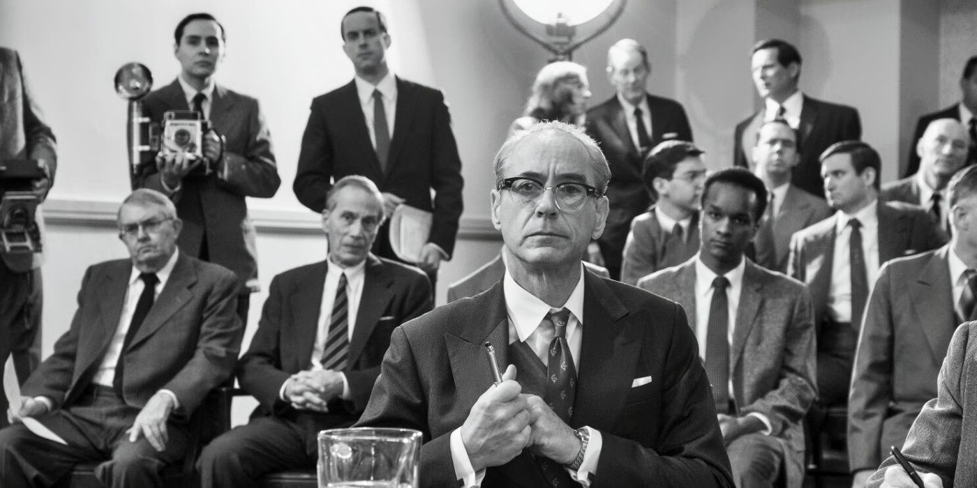 Robert Downey Jr. as Lewis Strauss sitting at a hearing in Oppenheimer