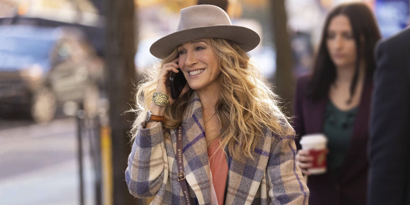 Sarah Jessica Parker smiling and talking on the phone in And Just Like That...