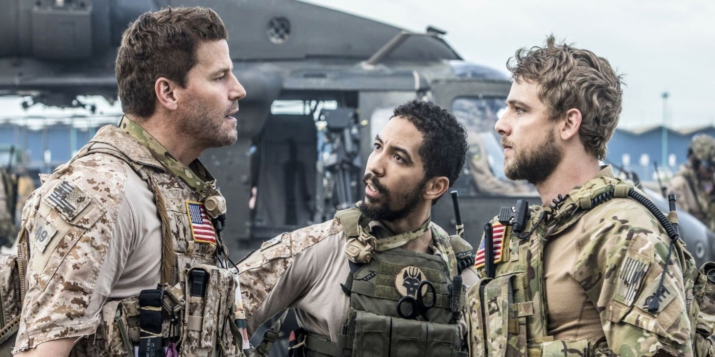 Clay Spenser (Max Thieriot), Jason Hayes (David Boreanaz), and Ray Perry (Neil Brown Jr.), talking heatedly in uniform beside a chopper in SEAL Team