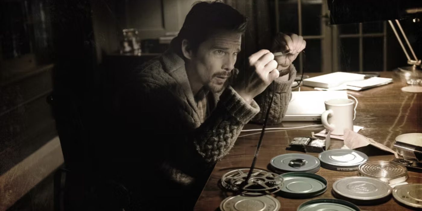 Ethan Hawke looking at a film roll in Sinister.