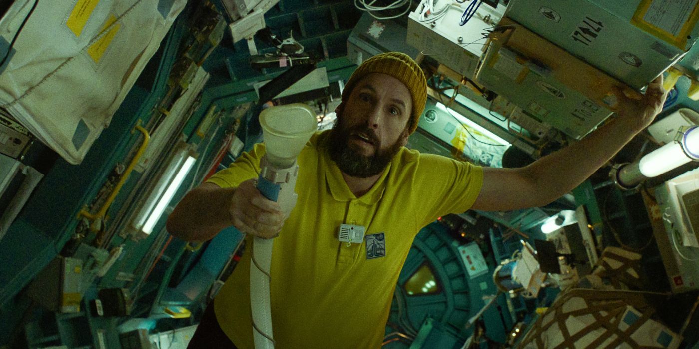 Adam Sandler as Jakub, holding a suction machine in a space shuttle, in Spaceman