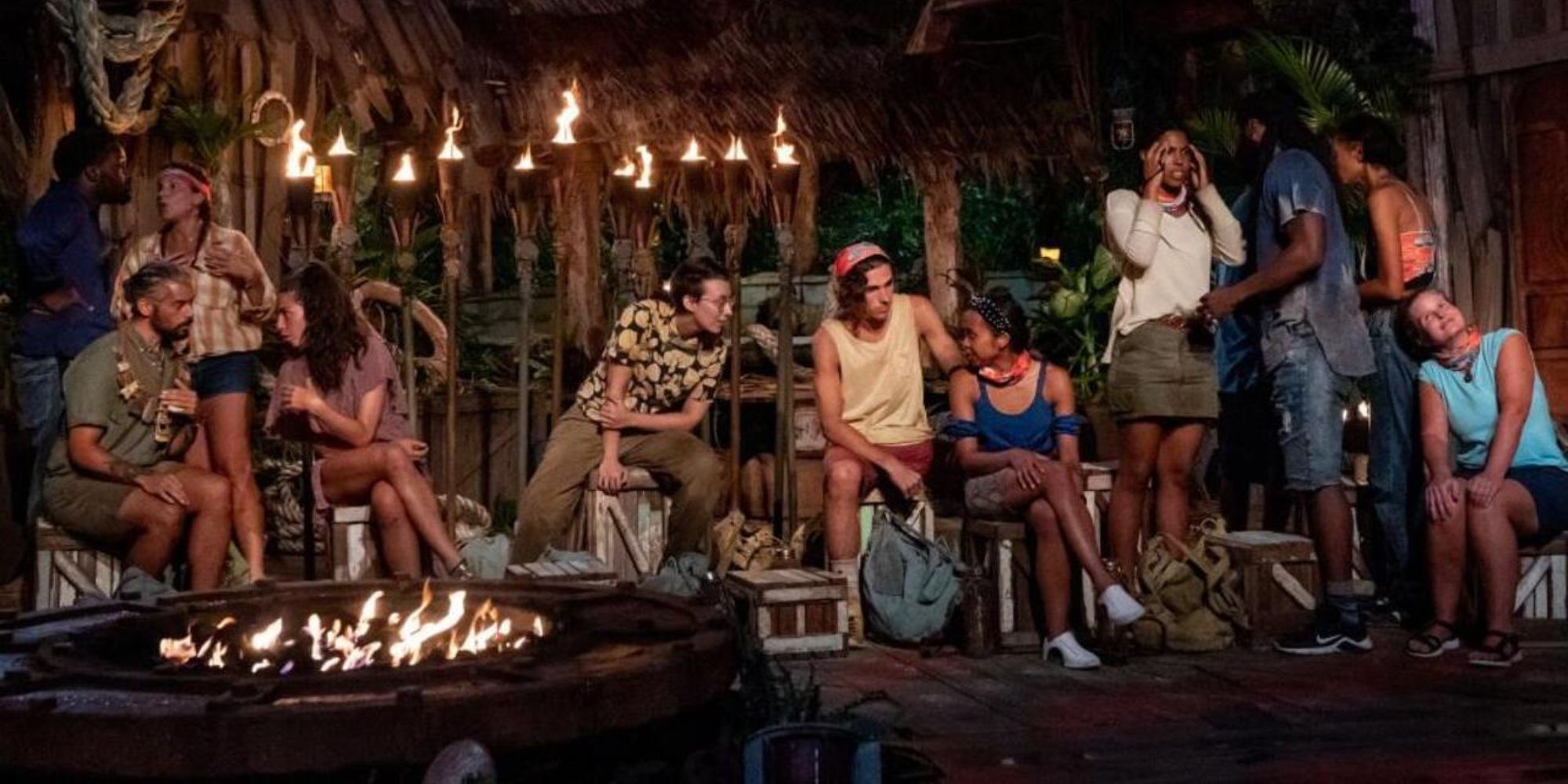 Contestants whisper and talk amongst themselves during tribal council in Season 41 of Survivor