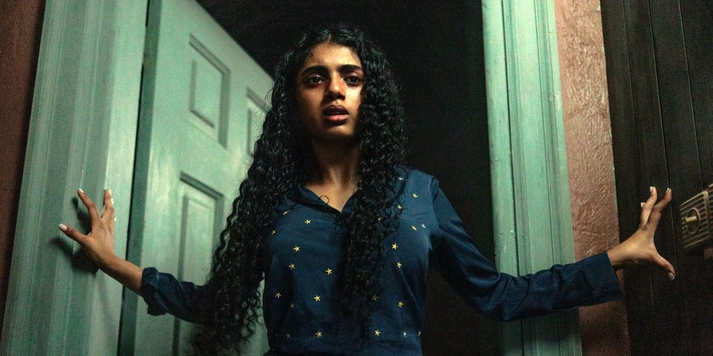 Avantika walking through a door with a frightened look on her face in 2024's Tarot
