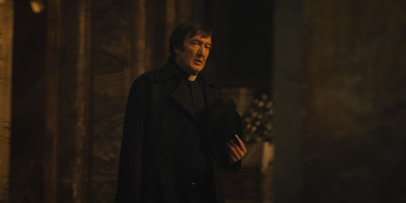 Ralph Ineson as Father Brennan, an exorcist, walking into a church in The First Omen