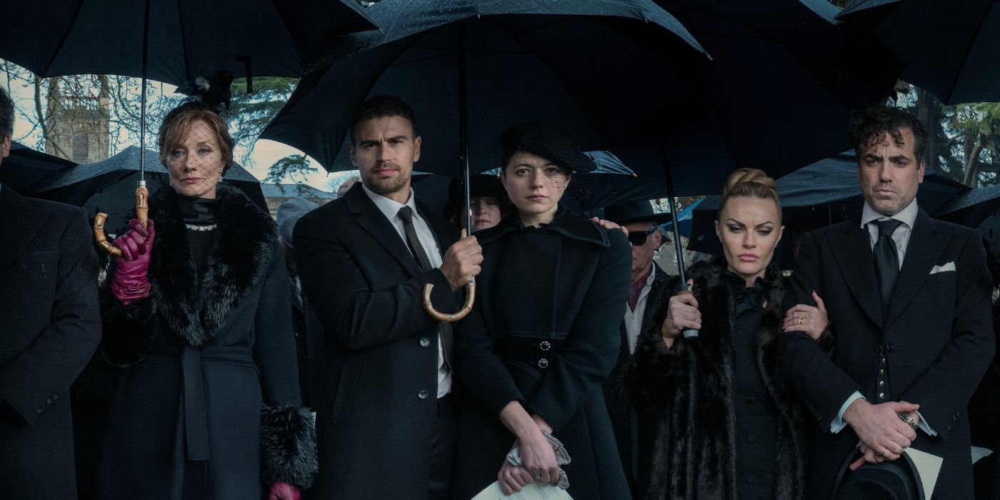 The cast stands holding umbrellas at a funeral in The Gentlemen