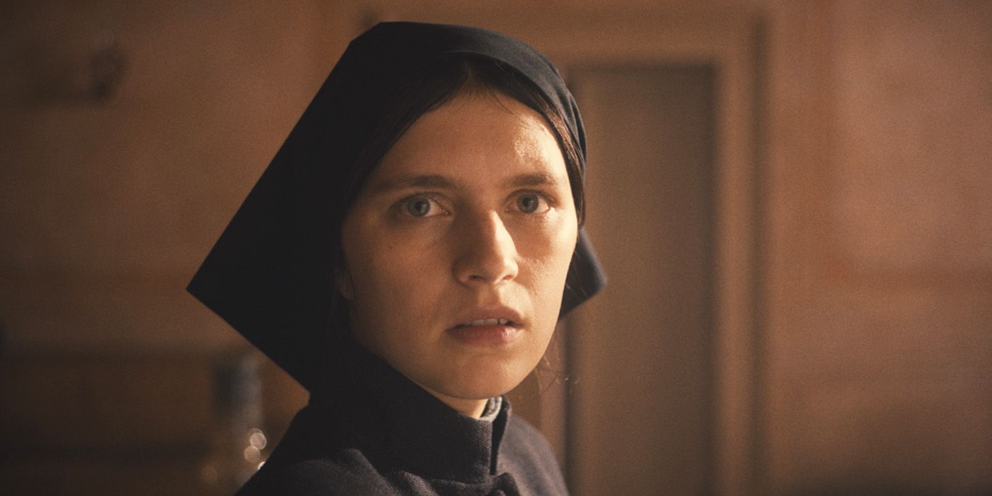 Nell Tiger Free as Margaret, a nun dressed in black, staring just behind the camera in The First Omen