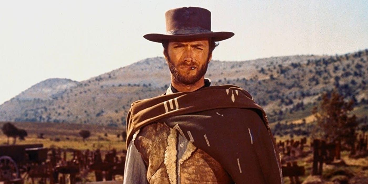 Clint Eastwood's nameless protagonist smokes a cigarette while standing in a dry, arid landscape.
