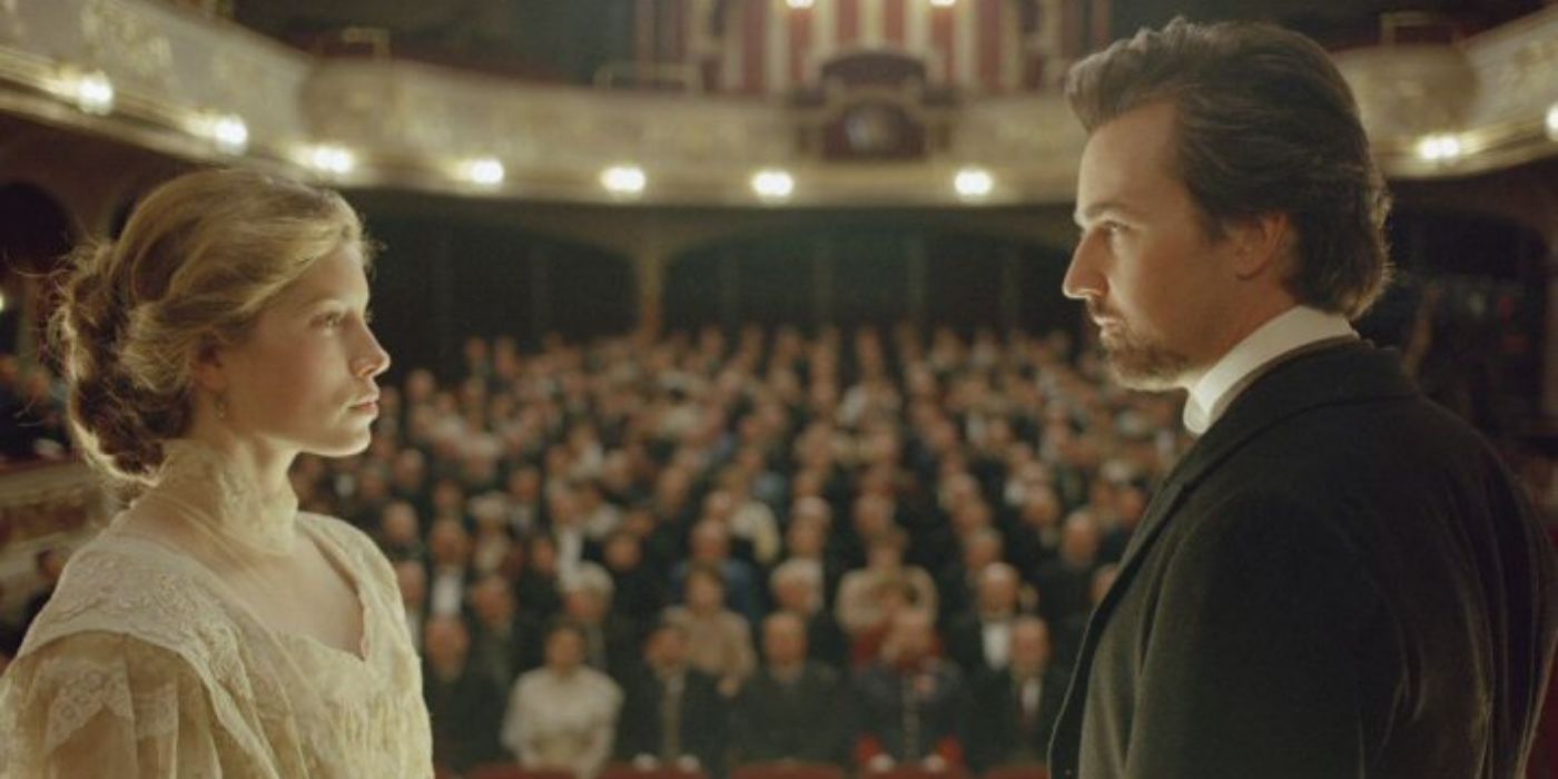 Sophie and Eisenheim looking at each other on stage in The Illusionist.