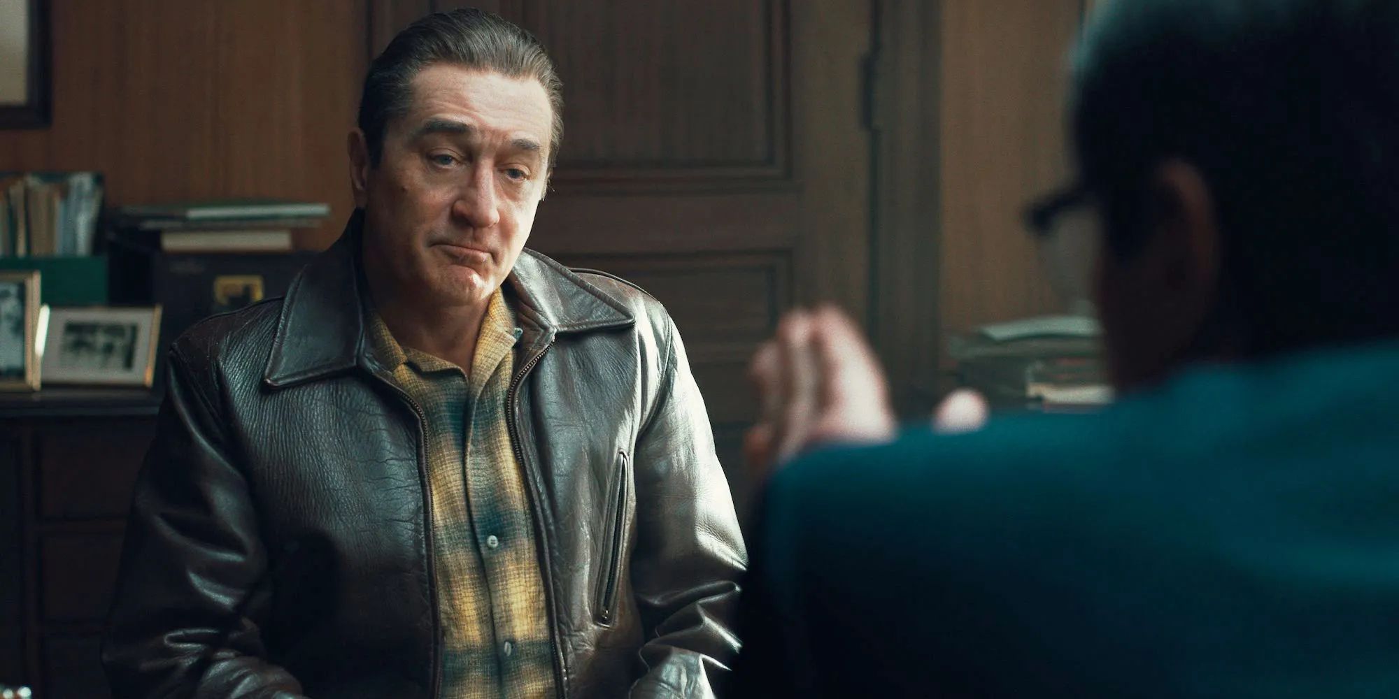 Frank Sheehan talking to someone with their back to the camera in The Irishman