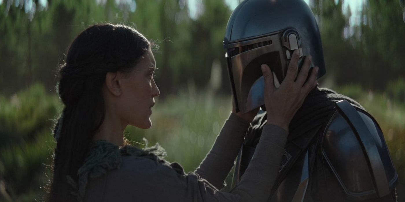 Omera, played by Julia Jones, lifts Din Djarin's helmet in The Mandalorian Season 1, Episode 4, 