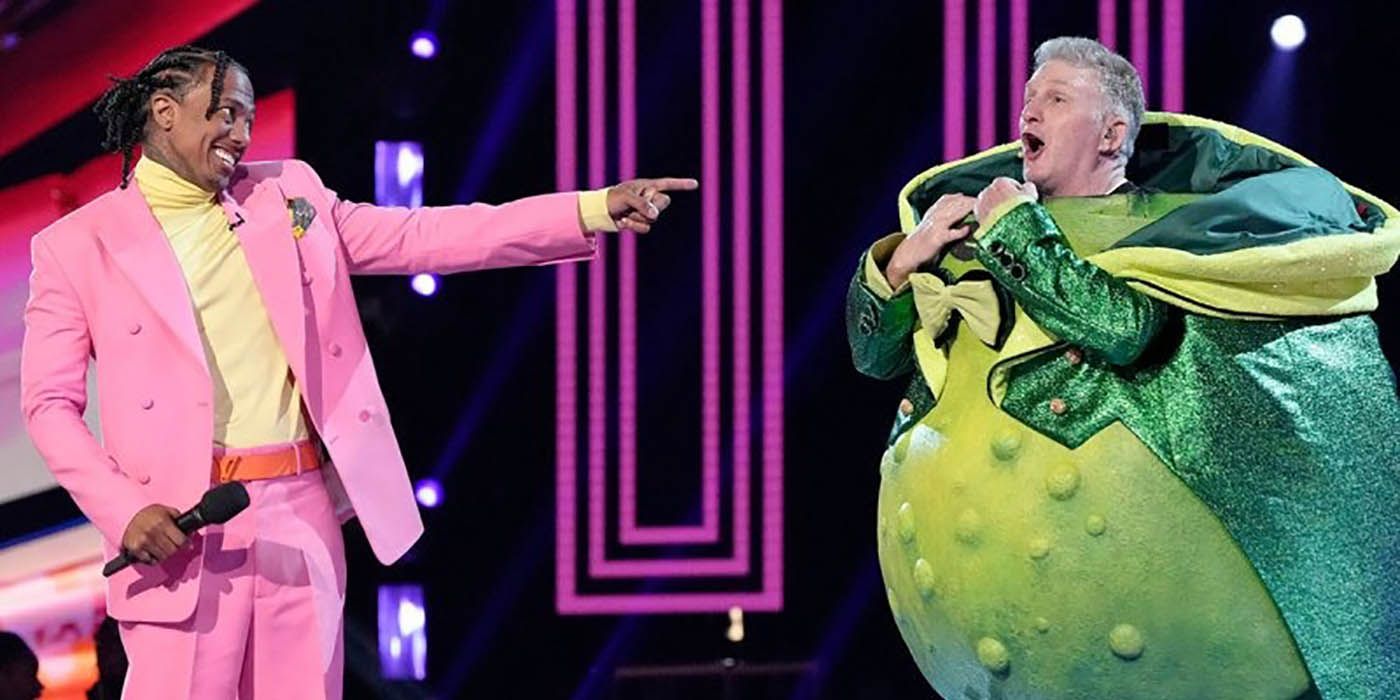 Nick Cannon with Michael Rapaport dressed as a pickle in a scene from The Masked Singer.