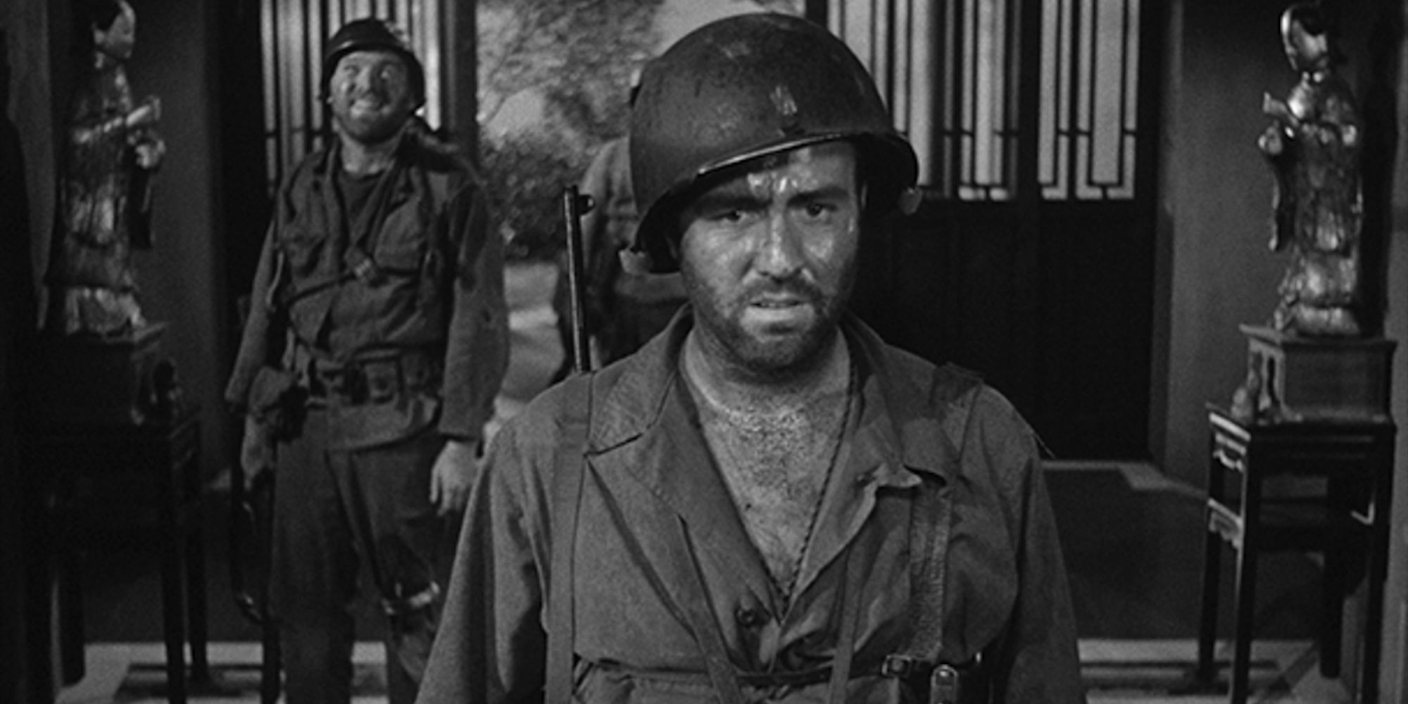 Steve Brodie as Lt. Driscoll looking worried with Gene Evans as Zack smiling in the background in The Steel Helmet