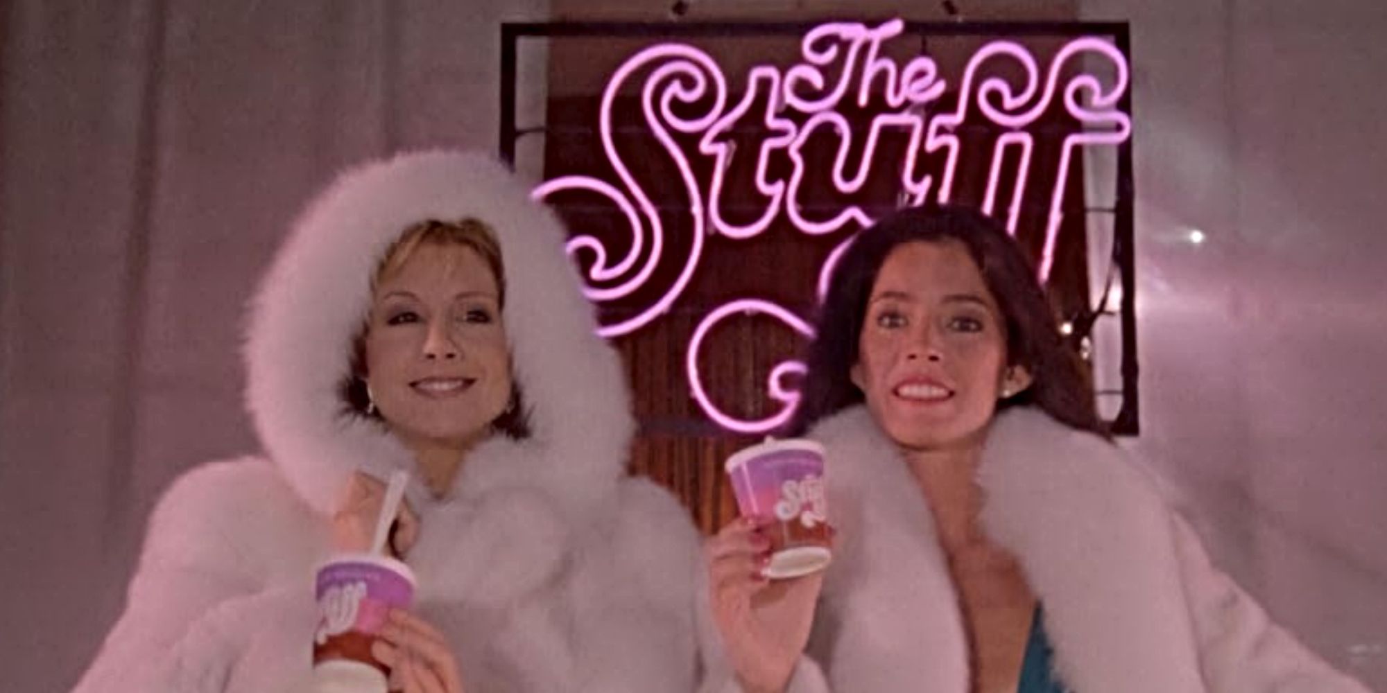 The Stuff models holding The Stuff in front of a neon The Stuff sign in The Stuff.