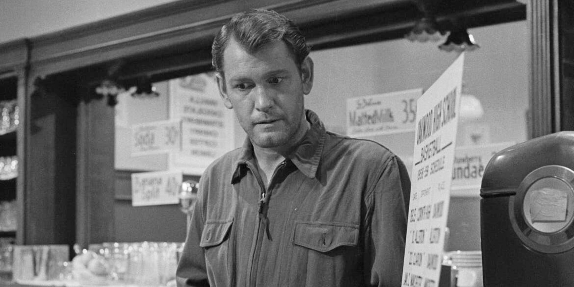 Earl Holliman standing alone in front a store counter in The Twilight Zone