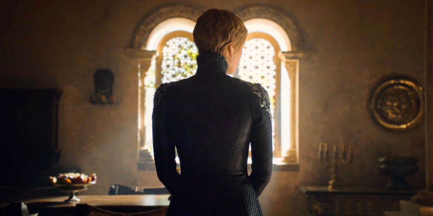 Cersei Lannister stands victorious in her chambers, with light glimmering in from her window as she wears a black dress.