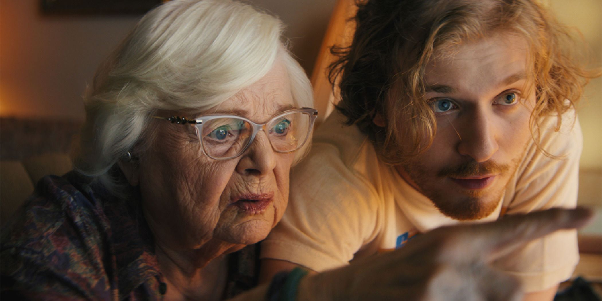 June Squibb (left) and Fred Hechinger (right) studying something on a computer screen in Thelma for Sundance 2024