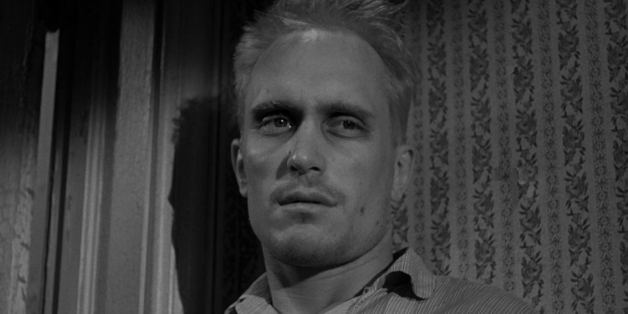 Robert Duvall as Arthur "Boo" Radley, standing in a corner looking sad in To Kill a Mockingbird