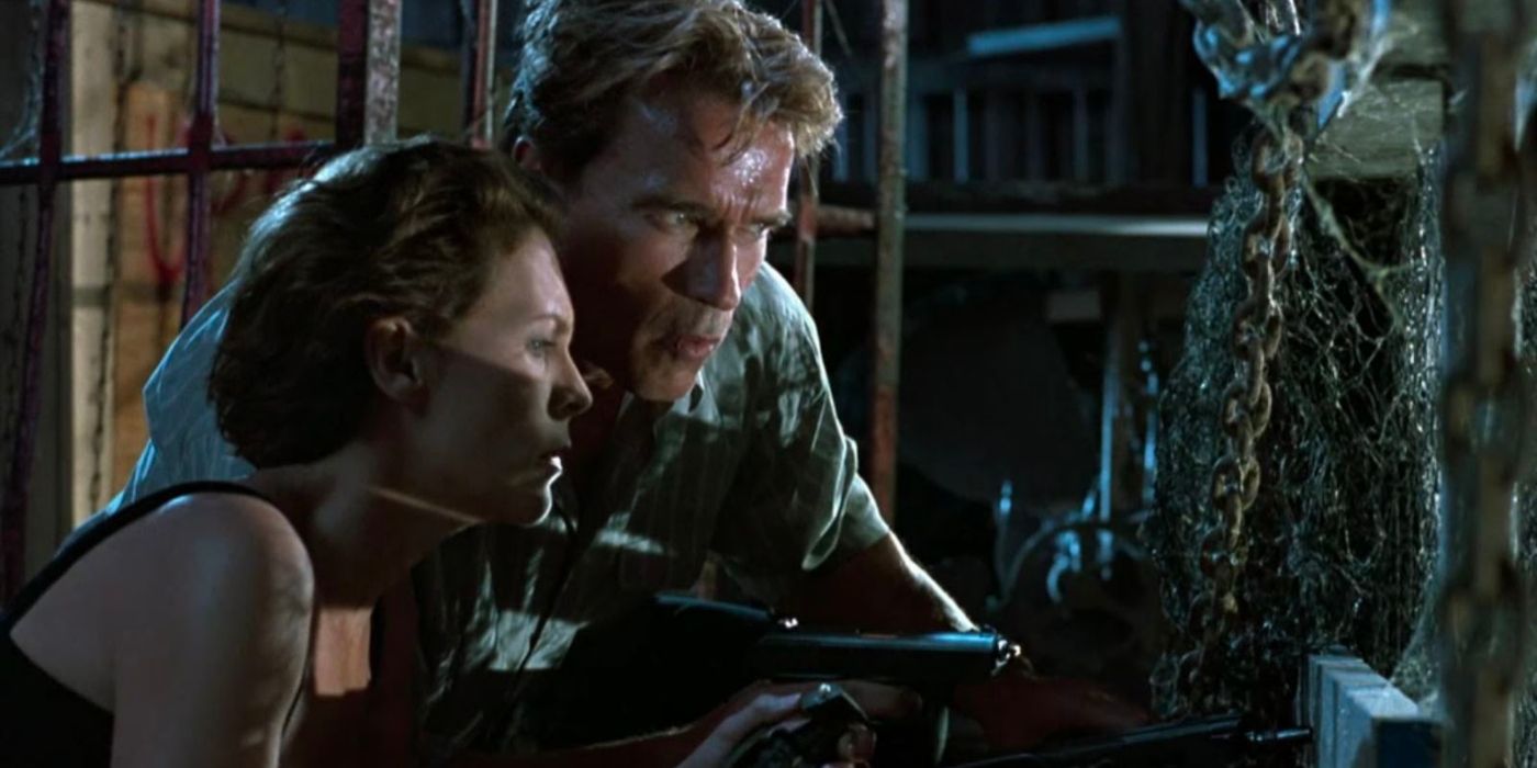 Arnold Schwarzenegger and Jamie Lee Curtis as Harry and Helen Tasker, spying on someone in True Lies