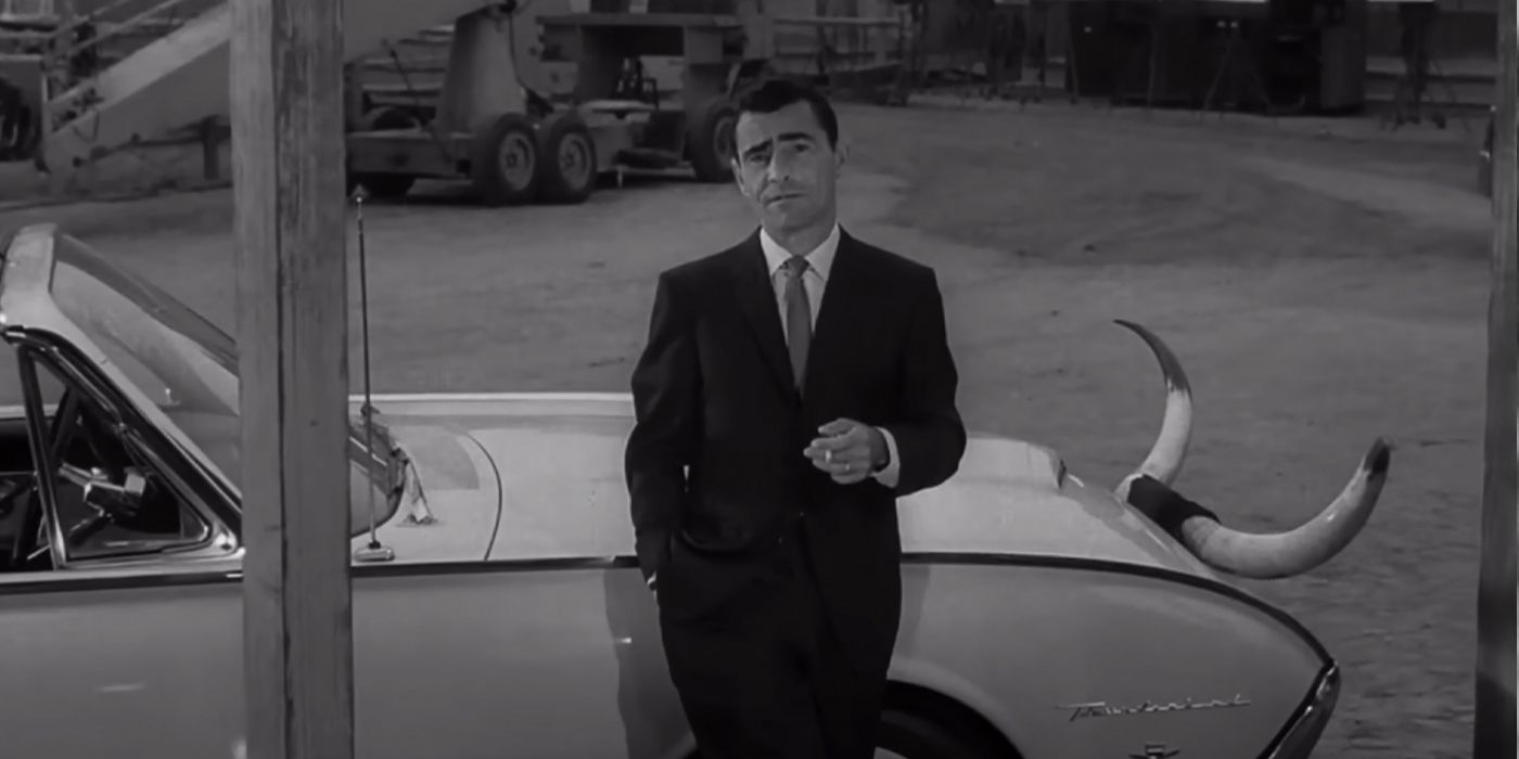 'Twilight Zone' host Rod Serling on the set, leaning against a car smoking