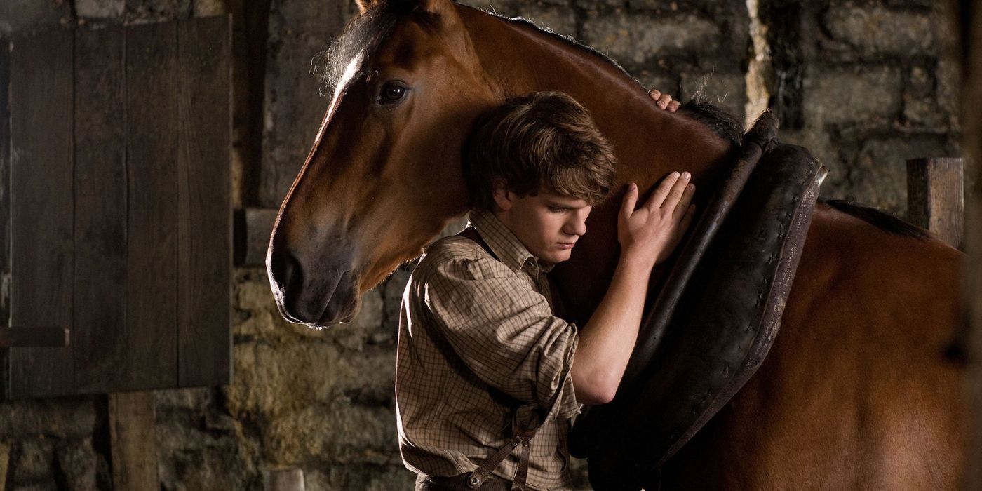 Jeremy Irvine as Albert embracing his horse, Joey, in the Steven Spielberg movie War Horse (2011)