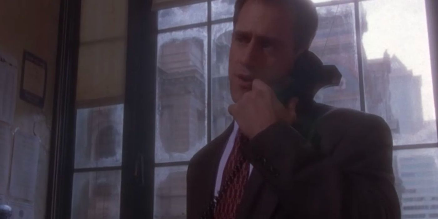 A police officer, Lt. Halperin (Christopher Meloni), speaks on the phone as he stands in front of a large, dirty window.