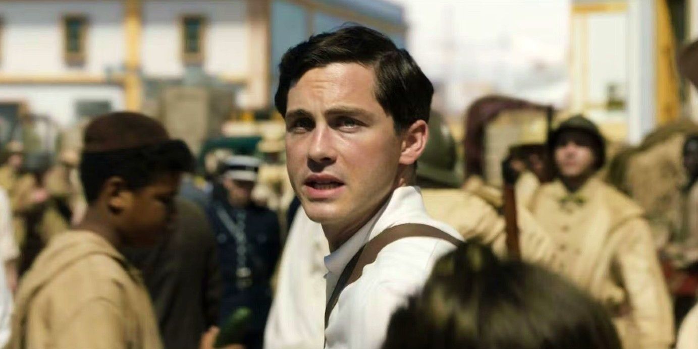 Addy, played by Logan Lerman, looks up at the sky in a crowd in We Were the Lucky Ones