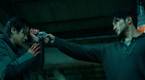 Sun Suk Ku as Jang Nan-gam, pointing his gun at the head of Choi Woo-shik's Lee Tang in A Killer Paradox