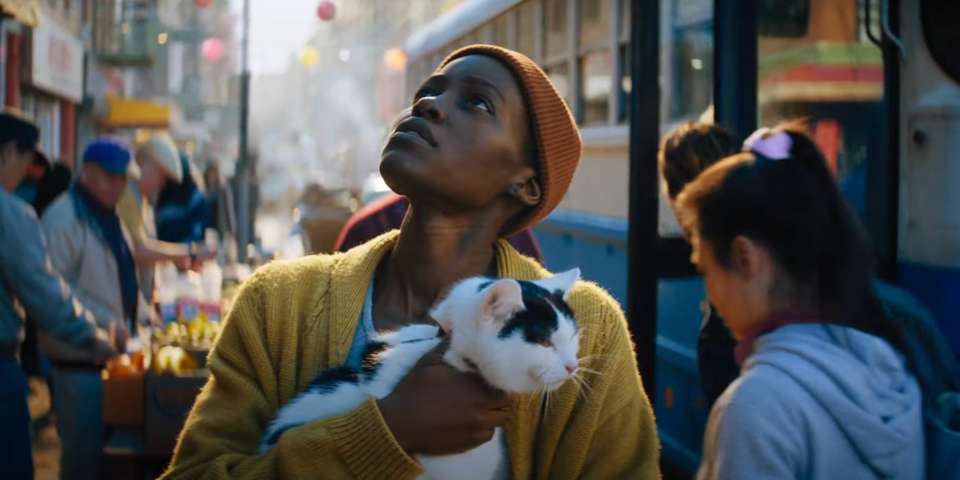Lupita Nyong'o as Sam, walking down a New York street, while holding her cat Frodo, in A Quiet Place: Day One