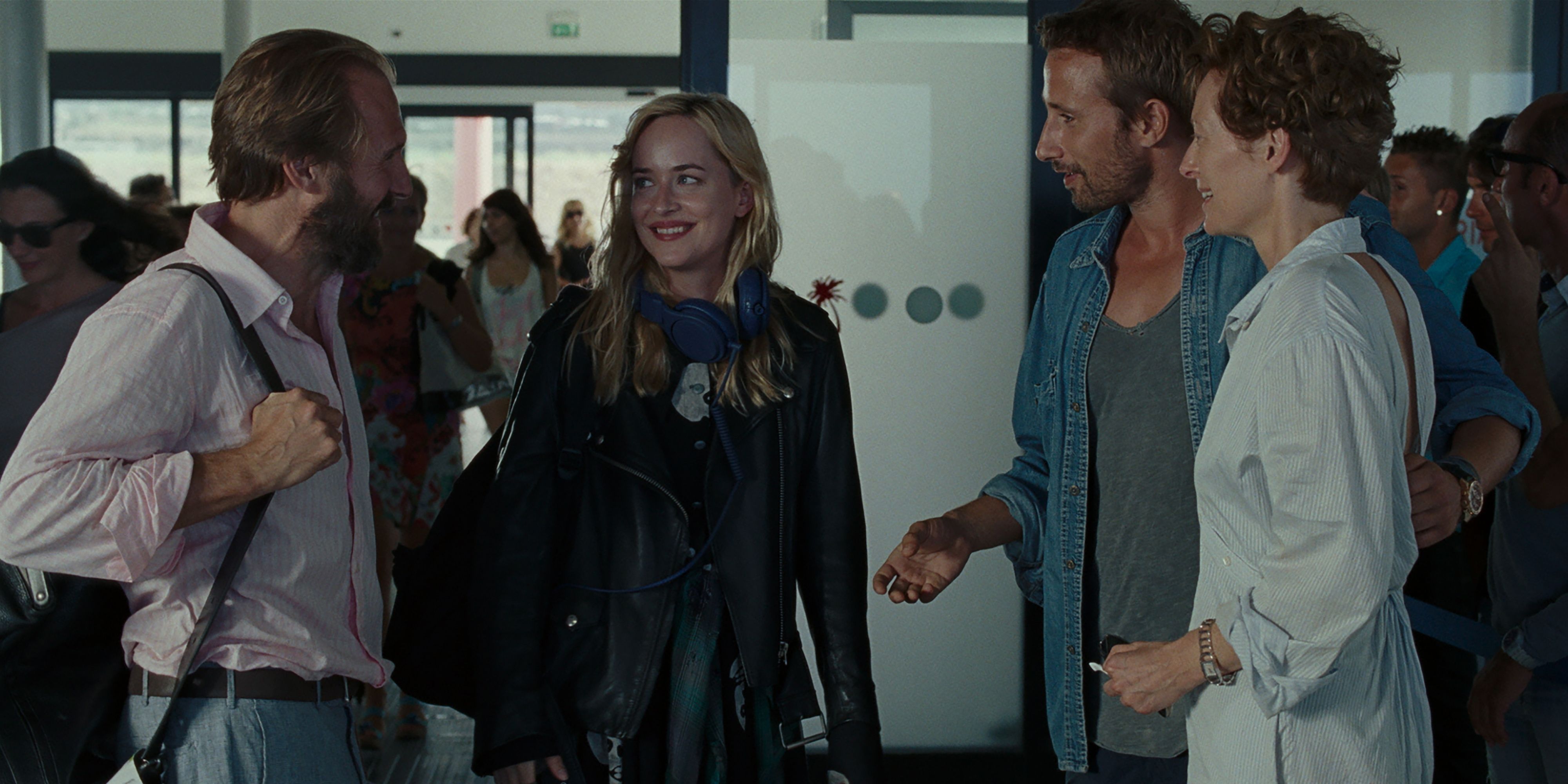 Four people meeting in an airport in the film A Bigger Splash